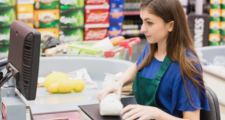 Woman cashier beeping an item